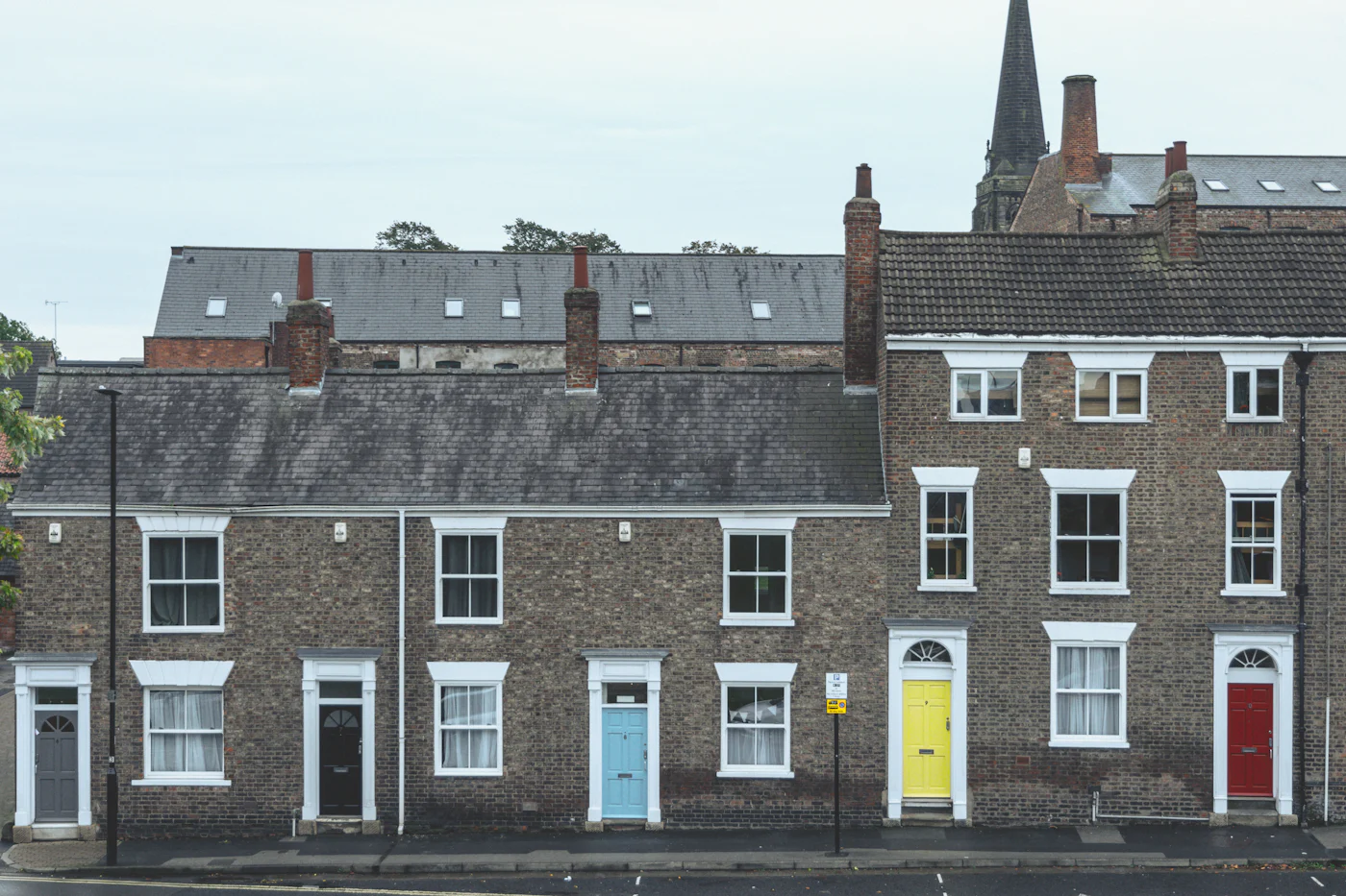 A row of terraced houses with colourful front doors