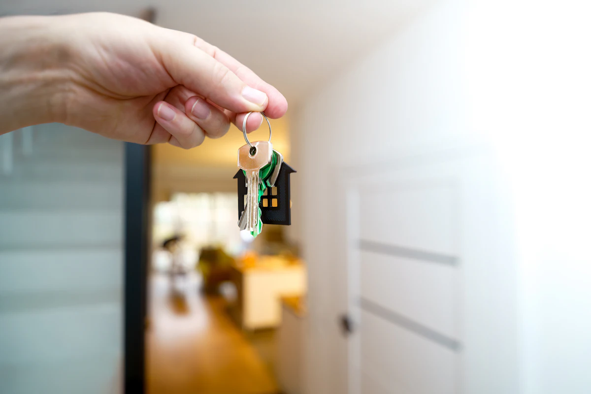 Holding house keys at a front door