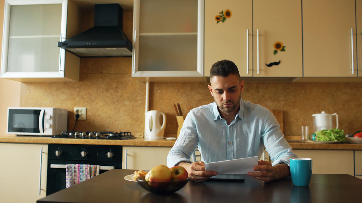 A landlord reading paperwork at a kitchen table